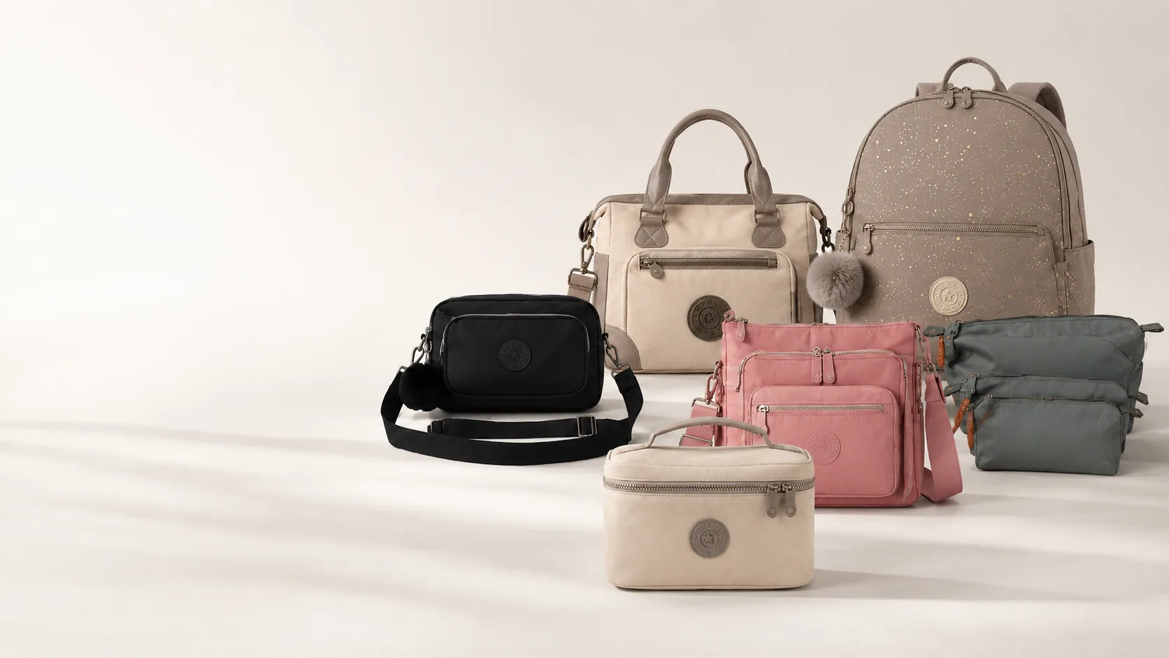 A coordinated selection of neutral, pink, black, and gray everyday bags